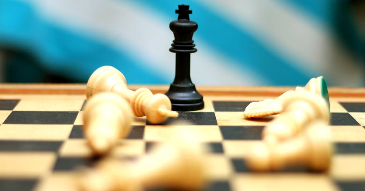 A lone chess king piece standing tall representing strategic deception and power play