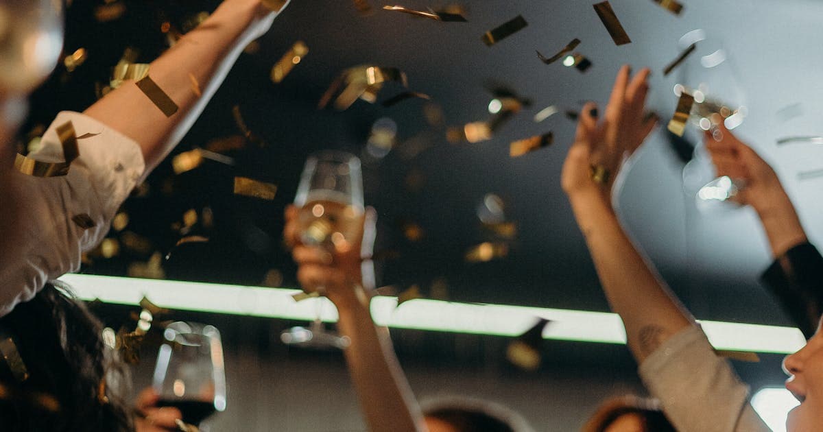 Friends celebrating together at a festive event with confetti